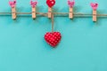 ValentineÃ¢â¬â¢s Day. Sewed pillow hearts row border on red clothespins at rustic white wood planks. Royalty Free Stock Photo